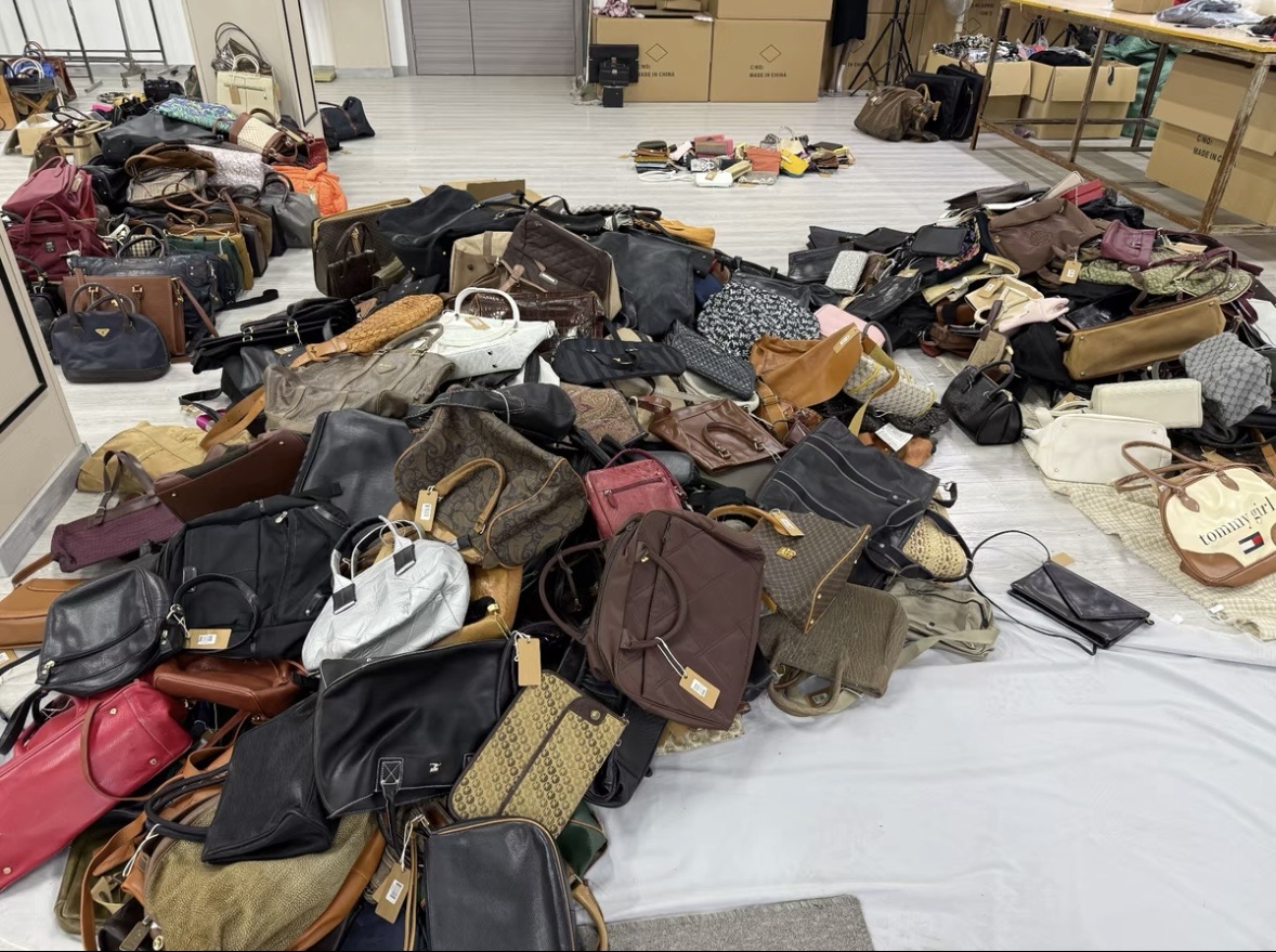 Mixed lot of preloved bags ready for sorting