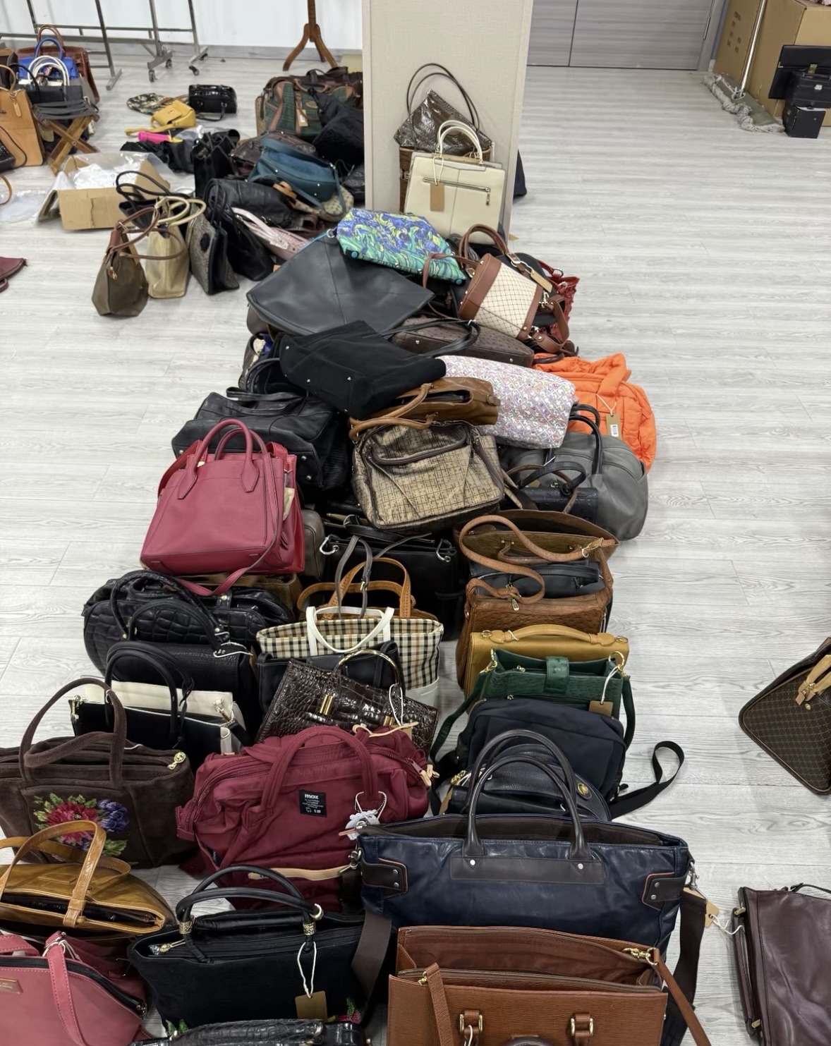 Curated selection of leather bags on warehouse floor